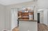 Modern kitchen with granite countertops, stylish ceiling fan, and stainless steel appliances in a cozy open layout.