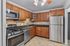 Modern kitchen with stainless steel appliances, granite countertops, and rich wood cabinetry, creating an inviting cooking space.
