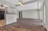 Spacious open-concept living area featuring elegant wood flooring and stylish kitchen with modern appliances.