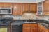 Modern kitchen with sleek granite countertops, elegant wooden cabinetry, and stainless steel appliances.