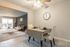 Chic open-concept living and dining area with modern decor, featuring a cozy seating space, elegant dining set, and natural light from large windows.