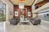 Elegant apartment lobby with modern decor, luxurious leather sofas, a stylish chandelier, and a serene ambiance.