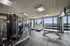 Modern fitness center with cutting-edge gym equipment, treadmills, and scenic window views for an invigorating workout experience.