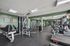 Spacious fitness center equipped with state-of-the-art machines, ample lighting, and modern interior design.