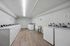 Bright and modern laundry room featuring state-of-the-art washing machines, sleek design, and ample space for convenience.