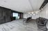Modern entertainment room with comfortable seating and large flat-screen TV in a stylish interior.