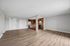 Modern open-concept apartment with sleek hardwood floors, contemporary kitchen featuring stainless steel appliances, and spacious living area.