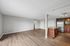 Modern open-plan apartment with sleek hardwood floors, bright living area, and stylish kitchen featuring stainless steel appliances and elegant cabinetry.