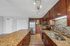 Modern kitchen with sleek granite countertops and rich wood cabinetry, featuring stainless steel appliances and stylish tile backsplash.
