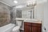 Sleek modern bathroom with stylish tiles, elegant lighting, and a contemporary vanity.