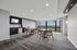Chic, modern communal area with stylish seating, large windows showcasing a stunning view, and a convenient kitchen setup perfect for gatherings.