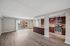 Spacious Open Concept Apartment with modern kitchen featuring stainless steel appliances, elegant wood cabinetry, and inviting living area with large sliding glass doors opening to balcony view.
