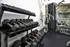 Modern gym with a variety of dumbbells and state-of-the-art exercise equipment, offering an ideal workout space for fitness enthusiasts.