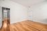 Bright and spacious room with elegant wooden flooring and clean white walls, perfect for creating a personalized living space.