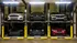 Innovative parking lift system showcasing a sleek, modern design with six cars seamlessly stacked in a secure, space-saving garage.