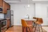 Sleek modern kitchen with granite countertops, stainless steel appliances, and elegant wooden cabinetry.