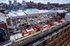 Exceptional rooftop terrace with luxurious red seating and modern fire pits, offering panoramic city views and a glass-enclosed space perfect for entertaining.