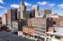 Breathtaking cityscape view showcasing historic and modern architecture under a sunny blue sky.