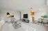 Bright, open-concept living room with modern furnishings and dining area view.