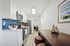 Contemporary kitchen with sleek white cabinetry, modern stainless steel appliances, and eye-catching blue subway tile backsplash.
