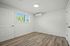 Bright and airy room with sleek wood flooring, ample natural light, and modern air conditioning unit.