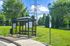 Charming suburban bus stop nestled amid lush greenery, offering convenient public transport access with a scenic backdrop.