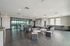 Modern open-concept lounge with stylish seating, sleek dark flooring, and ambient lighting, perfect for socializing and relaxation.