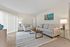 Bright and inviting living room featuring plush sofas, stylish decor, and a modern coffee table, perfect for relaxation and entertainment.