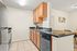 Chic kitchen with modern appliances, elegant black countertops, and warm wooden cabinets, perfect for culinary enthusiasts.