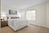 Bright and inviting bedroom with a queen-sized bed, elegant nightstands, and large window for natural light.