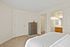 Bright and cozy bedroom featuring a spacious walk-in closet and elegant ensuite bathroom with modern fixtures.