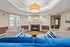 Inviting lounge area with plush blue sofas, cozy fireplace, and elegant lighting creating a warm ambiance.