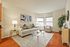 Bright and inviting living room featuring elegant modern decor, plush seating, and large windows with natural light.