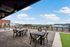 Expansive rooftop terrace with modern seating and panoramic city views, perfect for relaxation and gatherings.