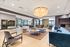 Elegant lobby area with modern seating, large windows, and a stunning chandelier, perfect for welcoming guests.