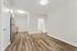 Modern apartment with elegant laminate flooring, stainless steel kitchen appliances, and a bright, open layout.