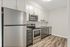 Contemporary kitchen featuring sleek stainless steel appliances, elegant white cabinetry, and granite countertops with modern flooring.