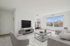 Inviting living room with modern furniture, large windows, and natural light.