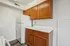 Bright kitchen with wooden cabinets and a white refrigerator.