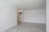 Bright and airy room with modern light wood flooring and a spacious closet, perfect for versatile living space.