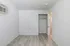 Bright room featuring fresh white walls, an elegant parquet floor, roomy closet, and convenient wall-mounted air conditioning.