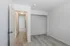 Bright, welcoming hallway with elegant light wood flooring and freshly painted walls, leading to spacious rooms in a modern apartment.