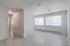 Bright and airy living space with modern flooring and large windows, perfect for a cozy apartment setting.