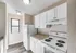 Charming kitchen with modern white cabinetry, sleek countertops, and stainless appliances, offering a bright and inviting space.