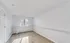 Bright and airy room with fresh paint, natural light streaming through a window, and elegant wood flooring creating a welcoming space.