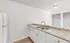 Bright and modern kitchen with elegant granite countertops and sleek white cabinetry, ideal for culinary adventures.