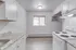 Charming kitchen with modern appliances, elegant granite countertops, and ample natural light through the window.
