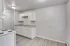 Chic modern kitchen with sleek white cabinetry, elegant countertops, and inviting lighting.