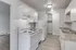 Bright and modern kitchen with sleek white cabinetry, ample counter space, and contemporary appliances, perfect for culinary enthusiasts.
