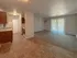 Inviting apartment interior with a cozy living room and modern kitchen, featuring ample natural light and stylish finishes.
